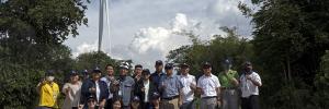 Lao PDR delegation in front of wind turbine in Thailand